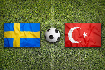 Image showing Sweden vs. Turkey flags on soccer field