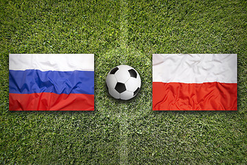 Image showing Russia vs. Poland flags on soccer field