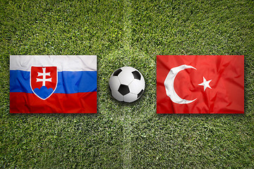 Image showing Slovakia vs. Turkey flags on soccer field