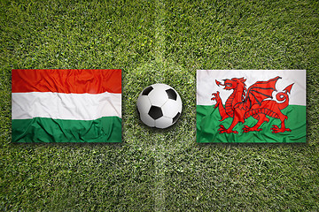 Image showing Hungary vs. Wales flags on soccer field