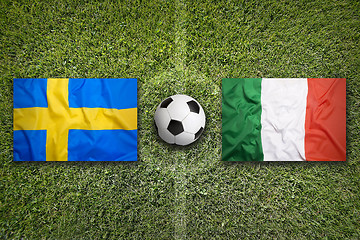 Image showing Sweden vs. Italy flags on soccer field