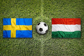 Image showing Sweden vs. Hungary flags on soccer field