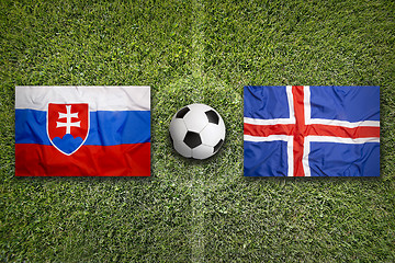 Image showing Slovakia vs. Iceland flags on soccer field