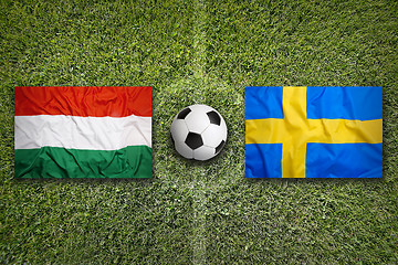 Image showing Hungary vs. Sweden flags on soccer field