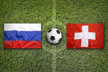 Image showing Russia vs. Switzerland flags on soccer field