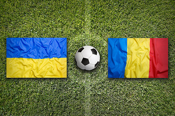 Image showing Ukraine vs. Romania flags on soccer field