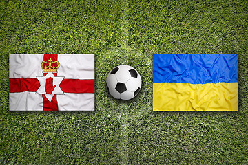 Image showing Northern Ireland vs. Ukraine flags on soccer field