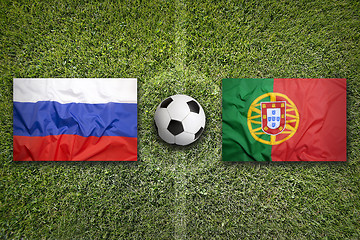 Image showing Russia vs. Portugal flags on soccer field