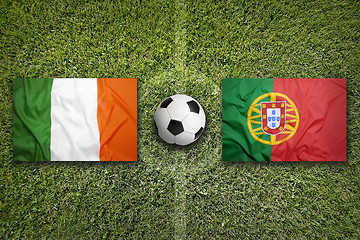 Image showing Ireland vs. Portugal flags on soccer field