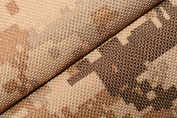 Image showing close up of worn out olive green tone camouflage fabric