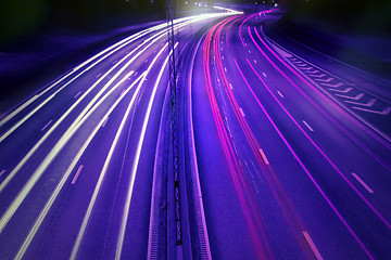 Image showing cars at night with motion blur.