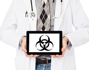 Image showing Doctor holding tablet - Warning! Biohazard!