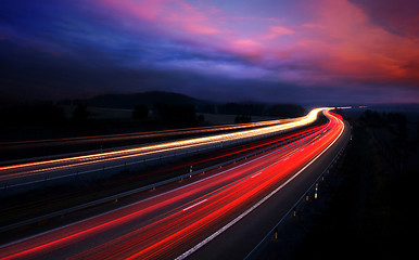 Image showing cars at night with motion blur.