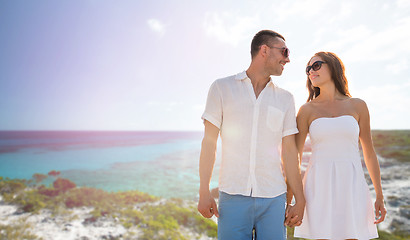 Image showing happy smiling couple over summer beach and sea