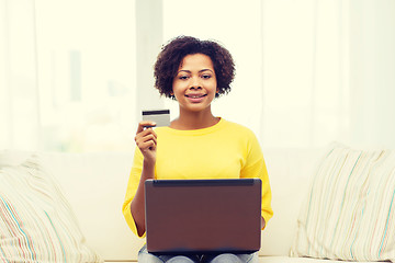 Image showing happy african woman with laptop and credit card