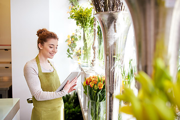 Image showing woman with tablet pc computer at flower shop