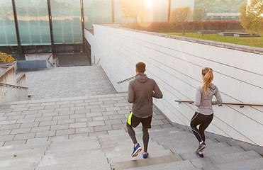 Image showing couple running downstairs on city stairs