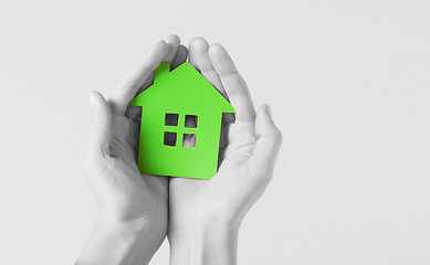 Image showing hands holding green paper house