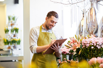 Image showing florist man with clipboard at flower shop