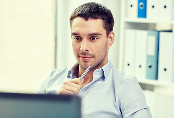 Image showing young businessman with laptop computer at office