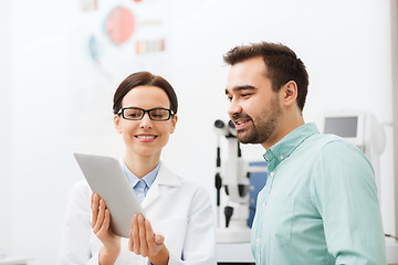 Image showing optician with tablet pc and patient at eye clinic