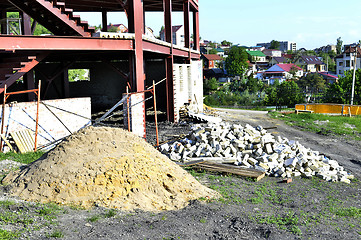 Image showing Construction materials and waste on the background of building under construction