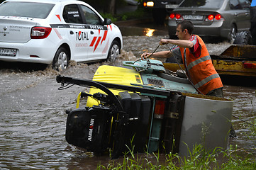 Image showing RUSSIA - MAY 27, 2016: An unidentified man raises overturned tec