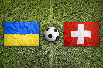 Image showing Ukraine vs. Switzerland flags on soccer field