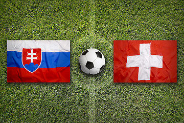 Image showing Slovakia vs. Switzerland flags on soccer field