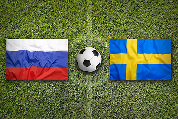 Image showing Russia vs. Sweden flags on soccer field