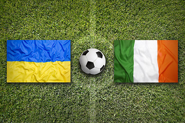 Image showing Ukraine vs. Ireland flags on soccer field