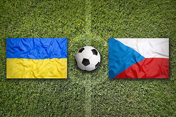 Image showing Ukraine vs. Czech Republic flags on soccer field