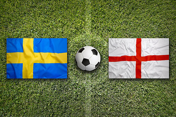 Image showing Sweden vs. England flags on soccer field