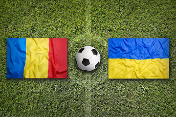 Image showing Romania vs. Ukraine flags on soccer field