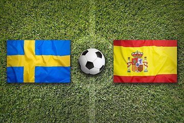 Image showing Sweden vs. Spain flags on soccer field