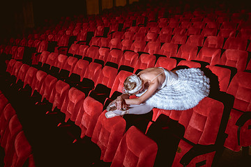 Image showing Ballerina sitting in the empty auditorium theater