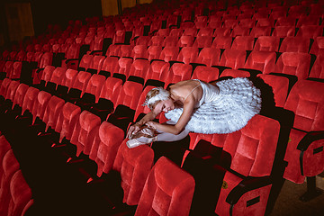 Image showing Ballerina sitting in the empty auditorium theater