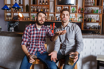 Image showing Young people with beer watching football in a bar