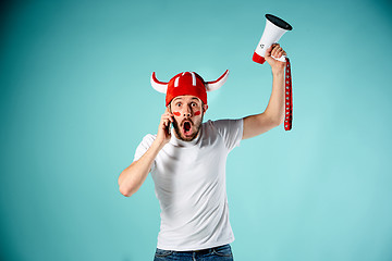 Image showing The face of football fan with different emotions on blue