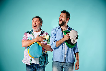 Image showing The two football fans singing the national anthem over blue