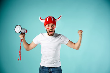 Image showing The face of football fan with different emotions on blue