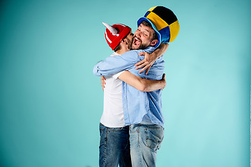 Image showing The two football fans over blue