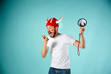 Image showing The face of football fan with different emotions on blue