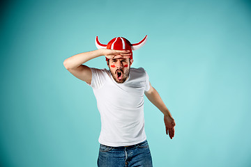 Image showing The face of football fan with different emotions on blue