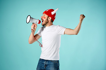 Image showing The face of football fan with different emotions on blue