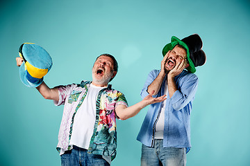 Image showing The two football fans over blue