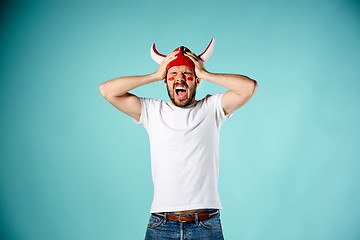 Image showing The face of football fan with different emotions on blue