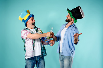 Image showing The two football fans over blue