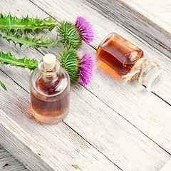 Image showing Flower thistles and extract from it