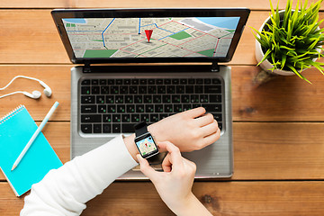 Image showing close up of woman with smart watch and laptop